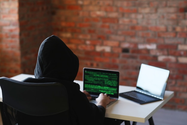 Hacker man on laptop Free Photo